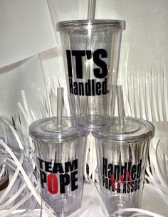 four tumblers with the words it's handle on them sitting next to each other