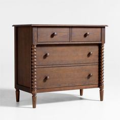 a wooden dresser with three drawers and two knobs on the front, against a white background