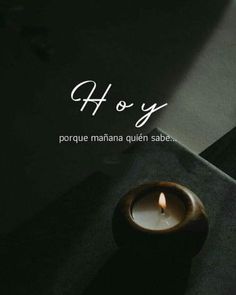 a candle sitting on top of a table next to a black box with the words ho y