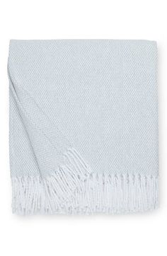 a white blanket with fringes on it