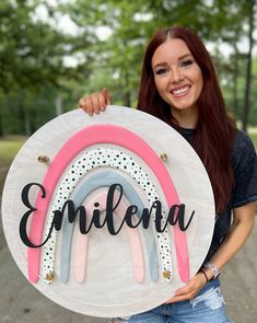 a woman holding up a sign with the word'embera'written on it