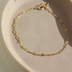 Timeless with a vintage style, the Sylvie Bracelet adds a little sparkle to your wrist! This bracelet is ideal for stacking amongst bolder chains like our Demi Alex or wear it alone for an easy elevated look. DETAILSBracelet Sizing: XS= 5.5", S=6", M=6.5", L=7", XL=7.5".5" adjustable spring hook clasp To measure your wrist size, wrap a piece of string around your wrist the way you would like the bracelet to fit. Then lay the string flat and measure the inches to get your size. Each piece of Toke Classic Everyday Gold Bracelet, Tarnish Resistant, Timeless Adjustable Gold Bracelet For Everyday, Timeless Everyday Adjustable Chain Bracelet, Timeless Everyday Gold Chain Bracelet, Everyday Timeless Adjustable Chain Bracelet, Classic Everyday 14k Gold Bracelet, Classic Adjustable Bracelet With Delicate Chain, Classic Link Bracelets With Delicate Chain, Classic Bracelets With Delicate Chain Link