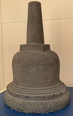 a large stone statue sitting on top of a blue table