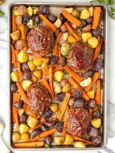 a pan filled with meat, potatoes and carrots