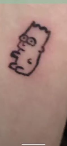 a drawing of a cartoon character on the back of a person's arm