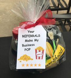 a plastic bag filled with popcorn and some sort of business card on top of it