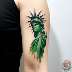 the statue of liberty tattoo is shown on the right arm and shoulder, with green ink