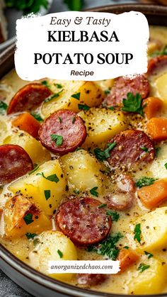 a close up of a bowl of potato soup with sausage and carrots on the side