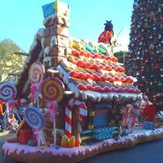 a large gingerbread house with candy and lollipops on it's roof