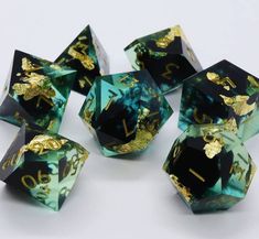 six green and gold dices with numbers on them, sitting next to each other