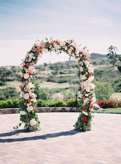 an archway decorated with flowers and greenery