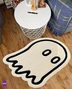 a white rug with a black ghost face on it