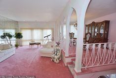 a living room filled with furniture and pink carpet