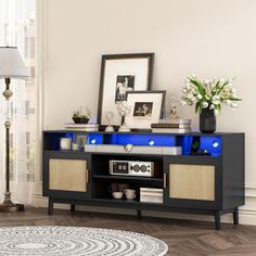 an entertainment center with blue lights and wicker baskets on it's sideboard