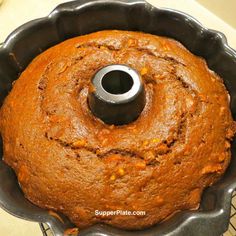 a bundt cake in a metal pan on a cooling rack