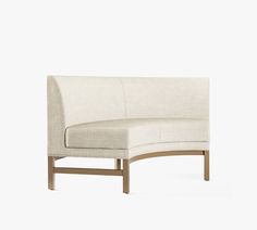 a white couch sitting on top of a wooden frame