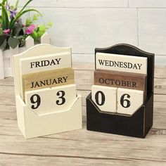 two wooden calendars sitting on top of a table