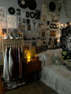 a bed room with a neatly made bed and lots of pictures on the wall