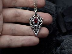 Whimsigoth vampire necklace made of: - sterling silver (Ag 925) - red garnet MEASUREMENTS Pendant length: 3.6 cm/ 1.4" Pendant width: 2 cm/ 0.7" Pendant weight: 5.2 gram Bail inner size: 4.2 x 4.3 mm You will receive this wirewrapped red goth pendant or necklace in a gift box with a little jewel pouch and silver polishing cloth. I made this bloody jewelry with beautiful red garnet and sterling silver 925. The garnet pendant can be perfect for your gothic, fantasy, or vampire outfits.  This unise Medieval Style Silver Necklaces For Fantasy Events, Silver Gothic Jewelry For Fantasy Events, Gothic Hand Forged Sterling Silver Jewelry, Gothic Engraved Jewelry For Larp, Gothic Hand Forged Pendant Necklace, Hand Forged Sterling Silver Gothic Jewelry, Silver Pendant Jewelry For Fantasy Events, Medieval Style Sterling Silver Jewelry Gift, Medieval Sterling Silver Jewelry Gift