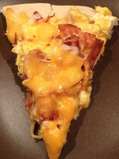 a slice of pizza with bacon and cheese on it