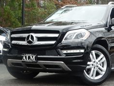 a black mercedes glk parked in a parking lot