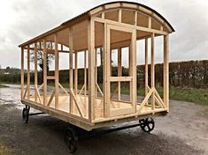 a small wooden structure sitting on top of a gravel road