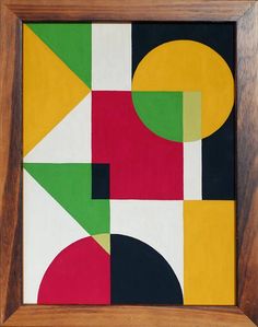 an abstract painting in a wooden frame on the wall, with various colors and shapes