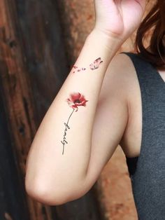 a woman with a flower tattoo on her arm