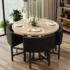 a dining room table with black chairs around it