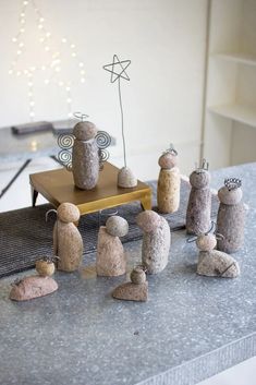 some rocks are sitting on top of a table and one is made to look like people