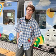 Add a pop of personality to your wardrobe with our Cartoon Embroidered Plaid Shirt! This playful shirt features an embroidered cartoon design on a classic plaid print, offering a unique and fun twist to a timeless style. Perfect for those who don't take themselves too seriously! Features: -66%Polyester 34%Cotton -Stand Collar -Full zip closure -Letter Graphic -Regular fit -High Street Style Casual Embroidered Collared Shirt, Cute Blue Button-up Shirt, Casual Collared Gingham Shirt, Casual Gingham Collared Shirt, Summer Casual Plaid Shirt, Spring Fun Streetwear Shirt, Fun Spring Streetwear Shirt, Preppy Plaid Short Sleeve Shirt, Cute Blue Collared Shirt