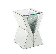 a glass table with silver glitter in the center and an upside down mirror on top