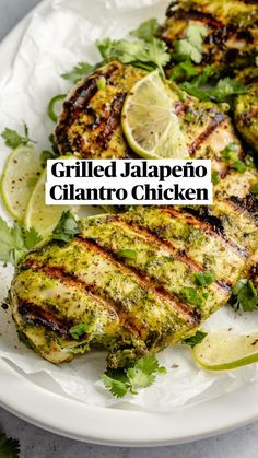 grilled chicken with cilantro and limes on a white plate