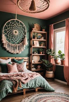 a bedroom decorated in green and pink with a large round dream catcher hanging above the bed