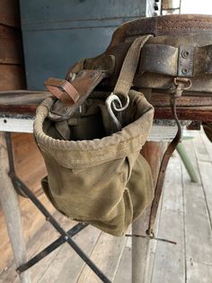 an old bag sitting on top of a wooden table