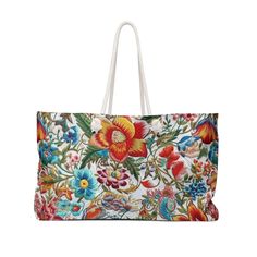 a large floral print bag with white handles