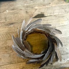 a metal wreath sitting on top of a wooden table