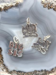 Sterling Big Sis charm, Sterling Mid Sis charm, Sterling Lil sis charm, Sterling Sister charm, Silver family charms, sterling Sorority charm Please view ALL pics for size and details Charms may pose a choking hazard These Sterling Sister charms are a perfect gift for a sibling or for that special Sorority sister!  Each charm is a bit  heavier weight and would be beautiful on a sterling silver chain or attached to your favorite charm bracelet. Our charms can be paired with your unique stampings, Collectible Nickel-free Sterling Silver Charms, Personalized Sterling Silver Charms For Collectors, Personalized Sterling Silver Charms, Sterling Silver Dangling Charms For Personalized Gifts, Nickel-free Sterling Silver Charms For Personalized Gifts, Personalized Silver Dangle Charms, Sterling Silver Pendant Charms For Mother's Day, Silver Dangling Charms For Mother's Day, Mother's Day Silver Dangling Charms