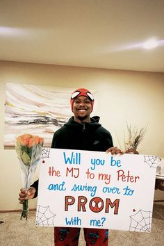 a man holding a sign that says, will you be the mj to my peter and i swing over to prom with me?