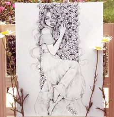 a drawing of a woman sitting in front of flowers