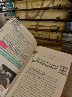 an open book sitting on top of a table next to suitcases and bookshelves