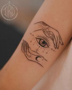 two hands touching each other with an eye in the middle and stars around them on their arm