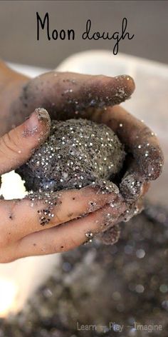 two hands are holding something that is covered in dirt and sand with the words moon dough written above it