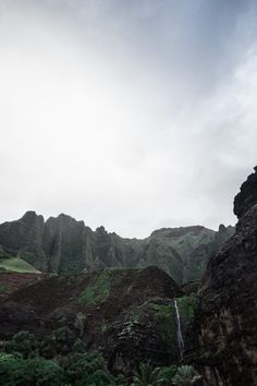 a waterfall in the middle of some mountains