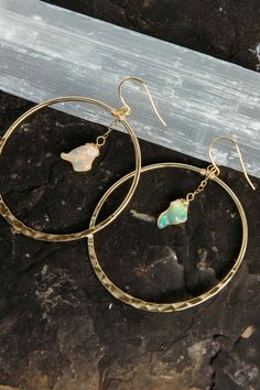 Timeless, beautiful, feminine earrings you can literally wear with anything. The dainty opals shine and flash in the light! Wear these from day to elevate your everyday look and into the night for that feminine, powerful touch. Opal is the stone of the spirit, amplifying your aura and all chakras. Opal gemstones 2" gold hammered hoops Weight: 1/4 oz Handmade in Arizona We try to match the images as best we can. All crystals & gemstones are unique & may vary in shape, size & appearance from what