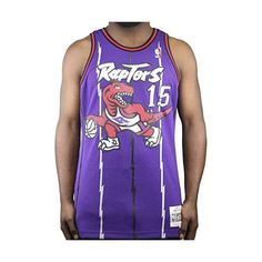 a man wearing a purple raptors jersey with a dinosaur on the front and number 15 on the back