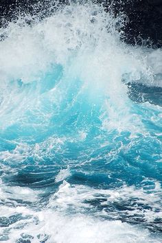 the water is splashing up against the rocks