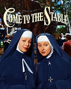 two women dressed in nun suits with the words come to the stable written on them