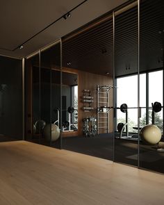 a gym with mirrors and exercise equipment in the corner, along with large windows to let in light