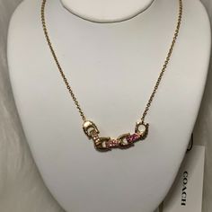 Coach Pave Signature Linked Necklace *New With Tags *Gold-Tone Chain Necklace (16") *Gold-Tone Pave Signature Linked *Pave Colors: Clear, Pink, Hot Pink Chic Pink Chain Jewelry, Elegant Pink Jewelry With Gold Chain, Pink Jewelry With Gold Chain, Pink Necklace With Gold Chain For Gift, Chic Coach Jewelry As Gift, Chic Coach Jewelry As A Gift, Chic Pink Necklace With Adjustable Chain, Pink Gold Chain Necklace For Gift, Circle Stone Necklace